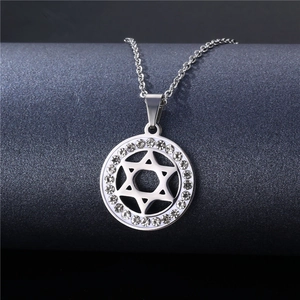Detailed shot of silver geometric star of david pendant with crystal rhinestones