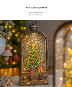Detail of vintage bronze Christmas snow lantern featuring a miniature tree and gift boxes