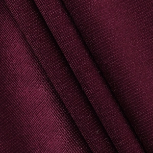 Macro detail of wine red irregular satin dress fabric showing fine mesh texture