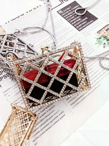 Detailed macro view of gold and silver rhinestone studded hollow metal lipstick holder case