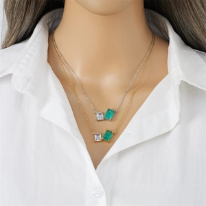 Elegant gold and silver titanium necklaces featuring green and white cubic zirconia pendants