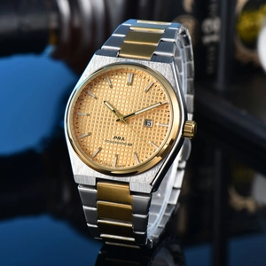 Macro detail of gold textured dial with date window and two-tone steel band for men