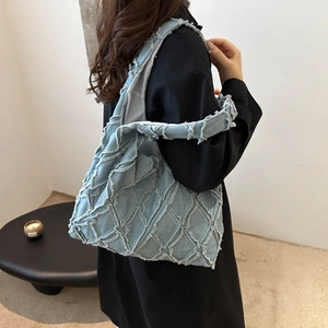 Chic light blue denim tote bag with checkered patchwork and fringed details for women