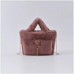 Detail of faux rabbit fur bag with reindeer metal clasp and long tassel decoration