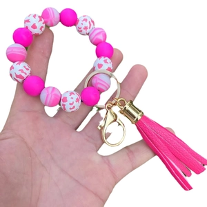 Pink silicone bead keychain bracelet with PU tassel and gold metal ring for women