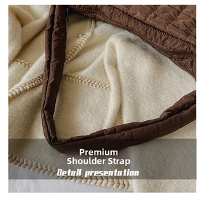 Close-up of premium quilted shoulder strap on brown padded space cotton bag