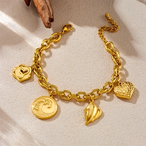 Gold plated stainless steel bracelet featuring ocean charms like waves, shell, and whale tail