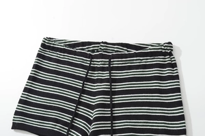 Detail of striped knit shorts with drawstring elastic waistband and soft ribbed texture