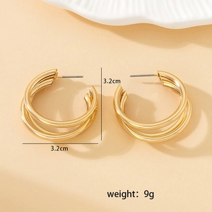 Detailed view of 3.2cm triple hoop golden metal earrings with clear size specifications