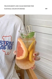 Vertical ribbed glass cup with fresh fruit slices and ice shown in use