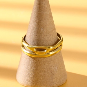 Minimalist double-layered gold geometric stainless steel ring on a display stand