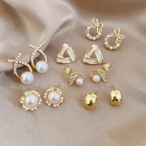 Detailed view of 6 pairs set French vintage pearl and rhinestone stud earrings on silk