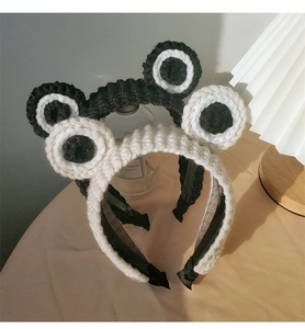 Detail of knitted crochet frog headband with big eyes and non-slip inner lining