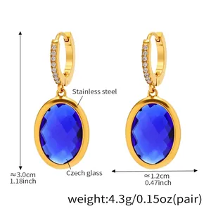 Detail of luxury gold stainless steel earrings with blue Czech glass and zircons