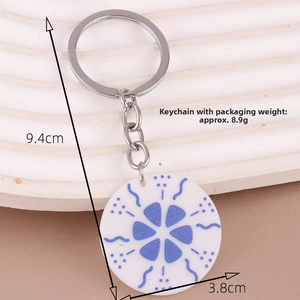 Detail of floral acrylic keychain with blue patterns and exact size measurements
