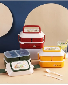 Close-up of double-layer rabbit lunch boxes in red, yellow and green with utensils