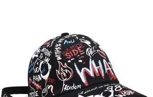 Close-up of black baseball cap featuring vibrant street style graffiti and embroidered patterns