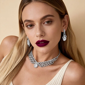 Close-up of elegant teardrop rhinestone necklace and earring set on female model
