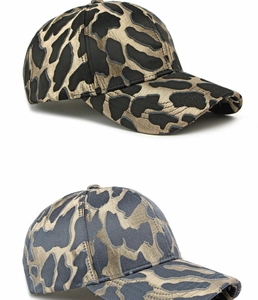 Detail of high-quality jacquard baseball caps in black-gold and gray-blue metallic leopard textures