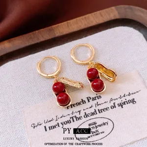 Elegant gold plated peanut drop earrings with red agate beads in vintage style