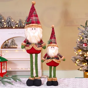 Close-up of two plush Christmas gnomes in red plaid outfits for holiday home decor