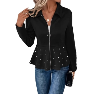 Detail of elegant black peplum jacket with white pearl beads and metal ring zipper
