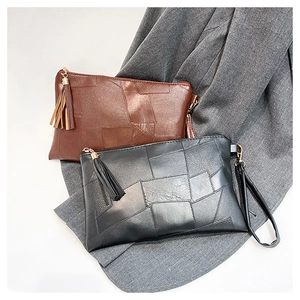 Close-up of brown and black leopard print handbags with fringe tassels and wrist straps