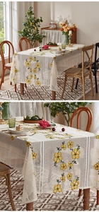 Detail of cream polyester lace tablecloth with floral embroidery and openwork stripes