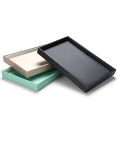 Detailed stack of black, gold, and mint green rectangular PU leather jewelry display trays