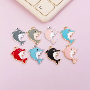 Detail of eight colorful dolphin charms in enamel alloy for DIY jewelry crafting