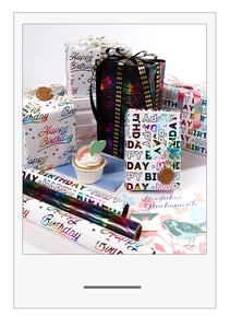 Detail of colorful laser foil Happy Birthday wrapping paper with gift box and ribbon