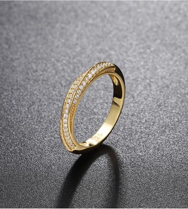 Macro shot of S925 sterling silver stamp on golden Moebius ring with paved diamonds