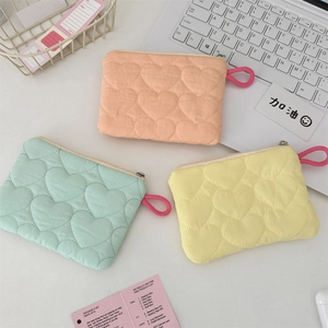 Quilted heart texture pouch set in pastel pink, mint green and yellow showing detail