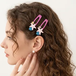 Starfish acrylic hair clips in purple and blue with cute floral details on a model