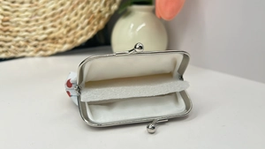 Detailed interior of the mini coin purse with silver clasp and soft inner lining