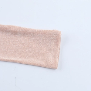 Close-up of the light pink ribbed knit fabric texture on the warm jumpsuit sleeves