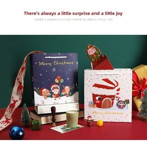Detailed view of Christmas gift bags featuring Santa and reindeer with white woven handles