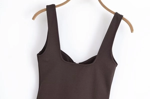 Close-up of deep brown sleeveless top with fine texture on a wooden hanger