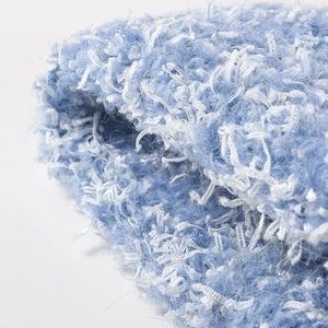 Close-up of soft blue and white mixed chunky knit fabric for winter ear protection hats