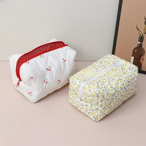 Detail of quilted floral makeup bags with cherry and blossom prints and inner lining
