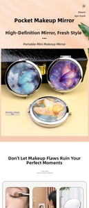 Close-up of portable mini makeup mirror with decorative butterfly pattern and double-sided lens