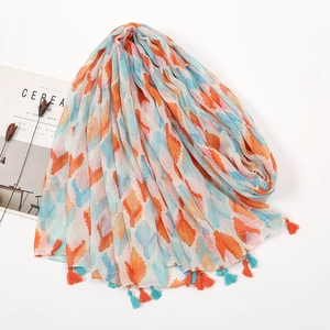 Close-up detail of Bohemian cotton scarf with orange and blue tassels and diamond print