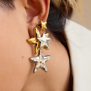 Two-tone 18K gold and silver stainless steel star earrings on a fashion model
