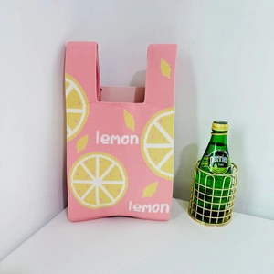 Pink knitted tote bag with yellow lemon jacquard pattern and lemon text design