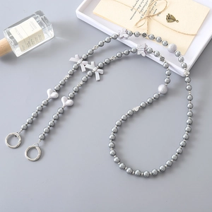 Gray faux pearl phone strap with acrylic heart and butterfly charms and spring clasp