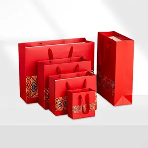 Set of five red Chinese style gift bags with ethnic geometric prints and woven handles