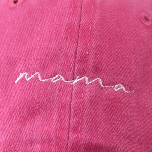 Magenta washed cotton baseball cap with white embroidered mama script logo in front