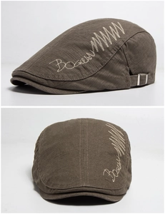 Close-up of olive green cotton ivy cap with detailed embroidery and metal buckle