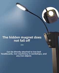 Close-up of flexible metal hose and magnetic base on black LED desk lamp