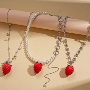Three-style set of silver necklaces with large red resin strawberry pendants